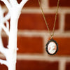 cameo pocket watch vintage necklace hanging on tree, cameo view