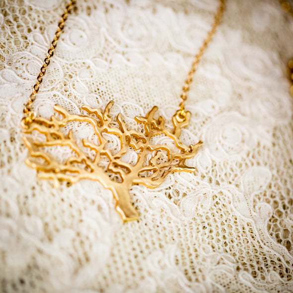 The Kamali large gold necklace large on lace close-up
