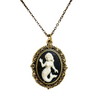 White resin mermaid on a black background in a brass filigree cabachon setting on a white background with chain
