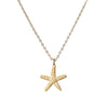 gold star fish necklace on white background