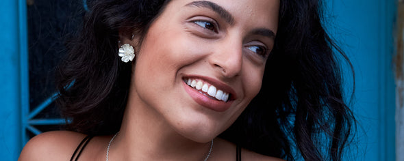 exotic israeli model wearing the evelyn lotus flower necklace