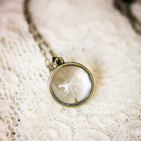 Brass dandelion seed necklace with single seed on lace