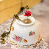 "Belle" Jar Rose Necklace with attached mirror pendant on a tea-cup with lace