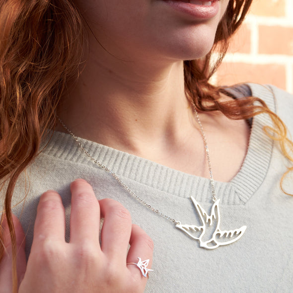 Beautiful model wearing silver large swallow or sparrow bird necklace rockabilly tattoo styleJPG