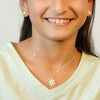 Beautiful teenager in white shirt wearing silver lotus earrings and necklace