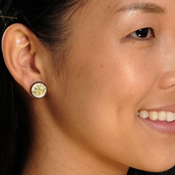 Beautiful woman smiling wearing succulent bubble glass and brass stud earrings