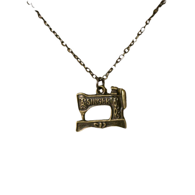 Brass Singer Sewing Machine Necklace on white backdrop
