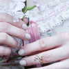 adjustable wrap leaf ring on model with pink flowers in her hands
