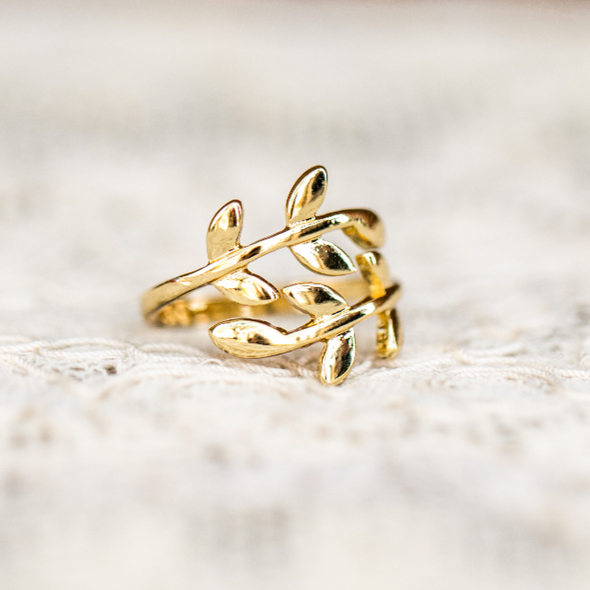 adjustable wrap leaf ring on white background lace