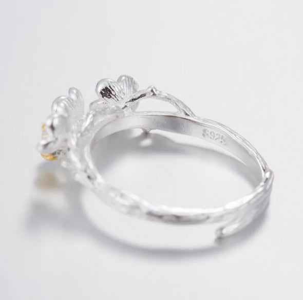 Plum Blossom Ring with sterling silver and 18k gold buds adjustable on a white background