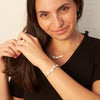 model wearing plum blossom bracelet, earrings, ring and necklace