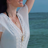 beautiful mermaid woman on beach vacation with shell necklaces on