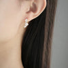 plum blossom earrings on ear