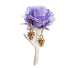tiny gold pinecone earrings on purple rose on white background 